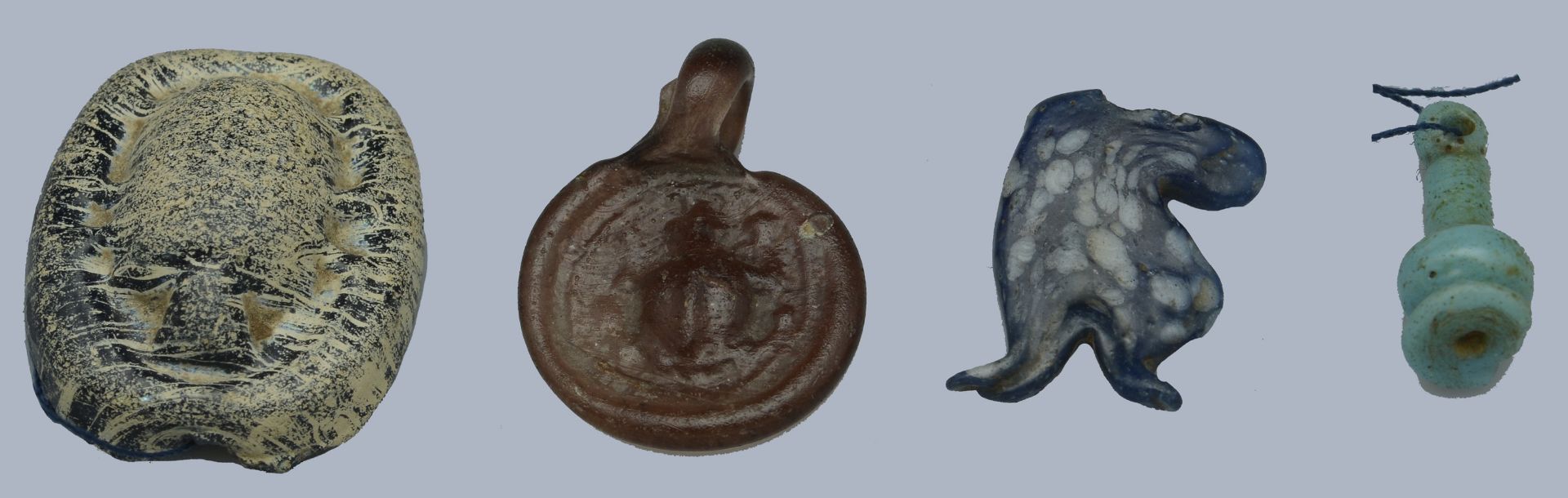 Egypt, New Kingdom (c. 1550-1069 BC), Glass (2), including blue and white Tauret amulet, 18m...