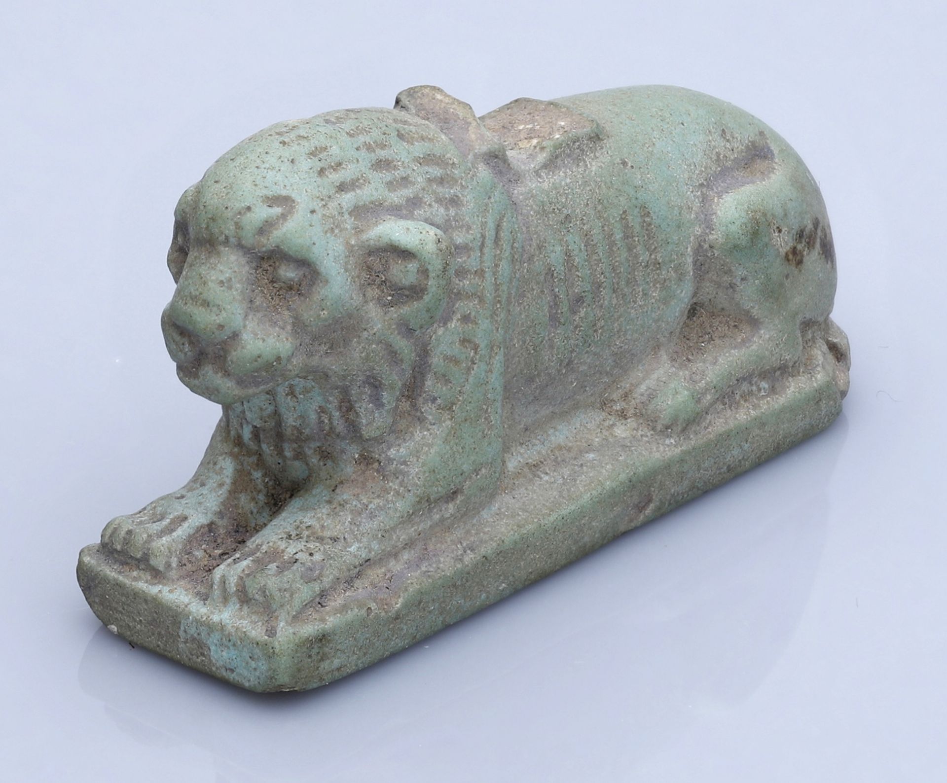 Egypt, Late Period (664-332 BC), A large green glazed faience amulet of a recumbent lion, 4....