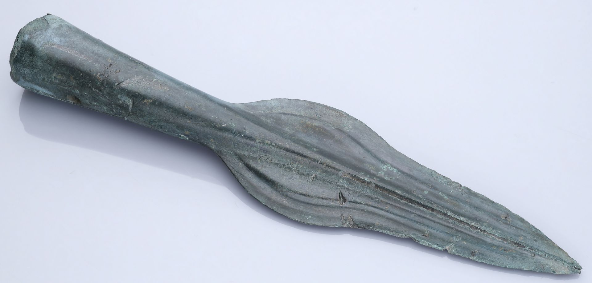 Bronze Age, A European spearhead, c. 1200-1000 BC, ogival shape with bevelled edges and prom...