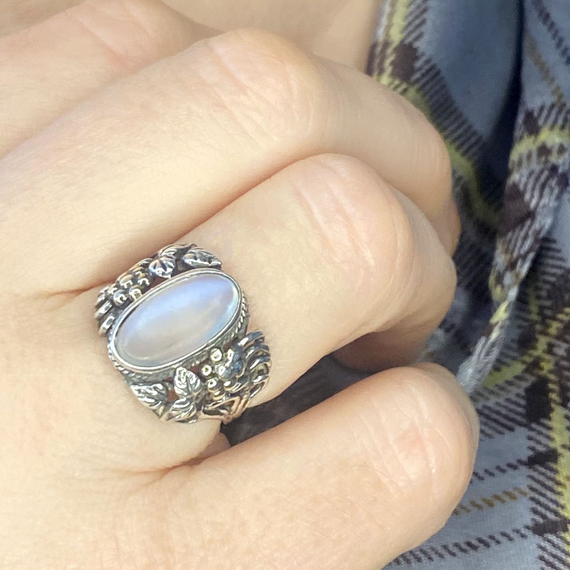 An Arts and Crafts silver moonstone ring, the cabochon collet set within a ropetwist border,... - Image 3 of 3