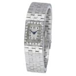 Swiss. Retailed by Benson. A lady's platinum and diamond-set rectangular wristwatch with lat...
