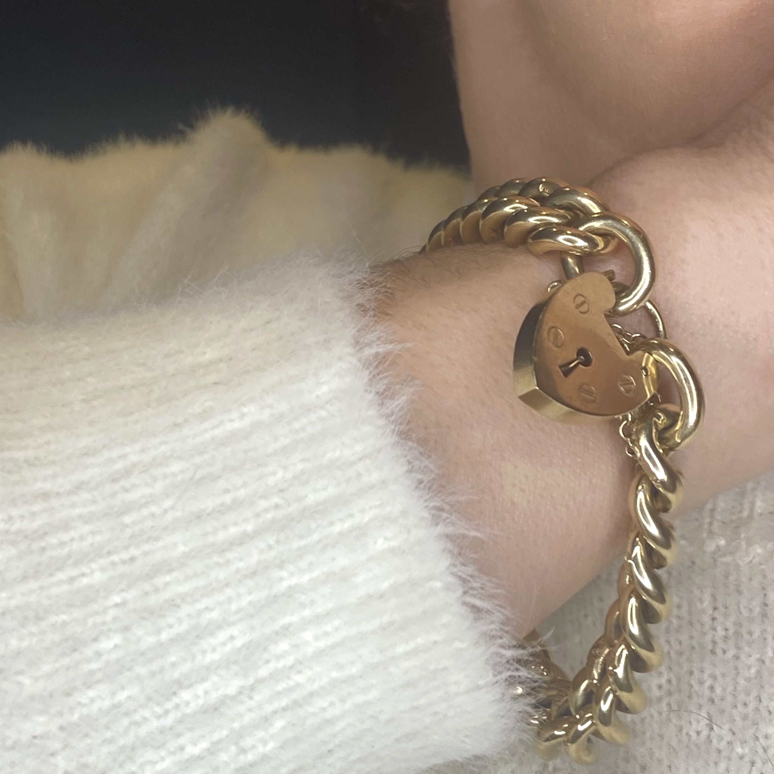 A gold curb-link bracelet, each link with scroll engraved decoration, with 9ct gold padlock... - Image 3 of 4