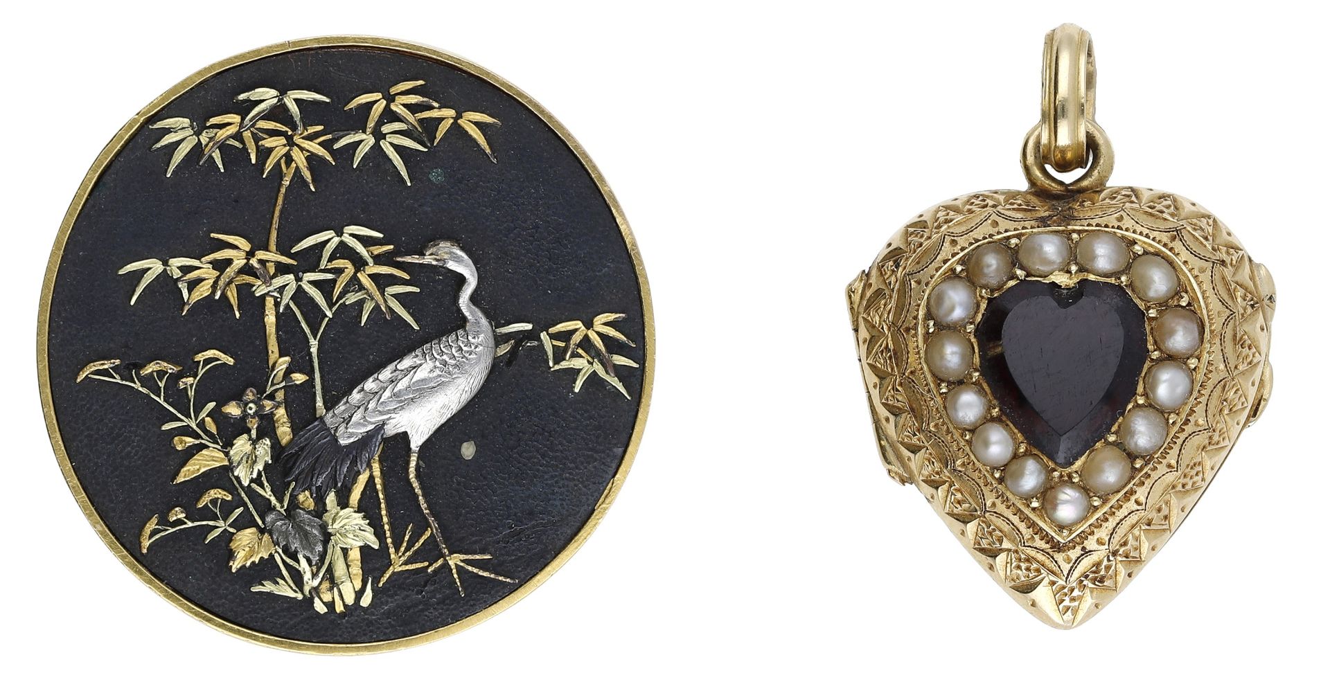 A Japanese brooch and a locket, the shakudo work circular brooch depicting a crane amidst ba...