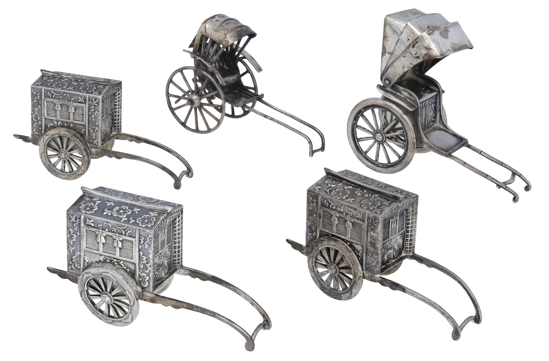 Three matching Japanese silver novelty pepperettes, modelled as wheeled palanquins, one rick...