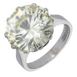 A diamond single stone ring, set with a brilliant-cut diamond of yellow tint, weighing 10.13...