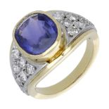 A sapphire and diamond dress ring, the cushion-shaped purple sapphire in a rubover setting b...
