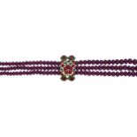 An Indian ruby bead necklace, the three-rows of graduated polished ruby beads, measuring app...