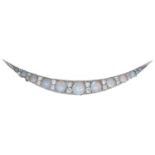 A late 19th century opal and diamond crescent brooch, the graduated opal cabochons spaced by...