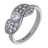 An 18ct white gold diamond set dress ring, the principal brilliant-cut diamond centred withi...