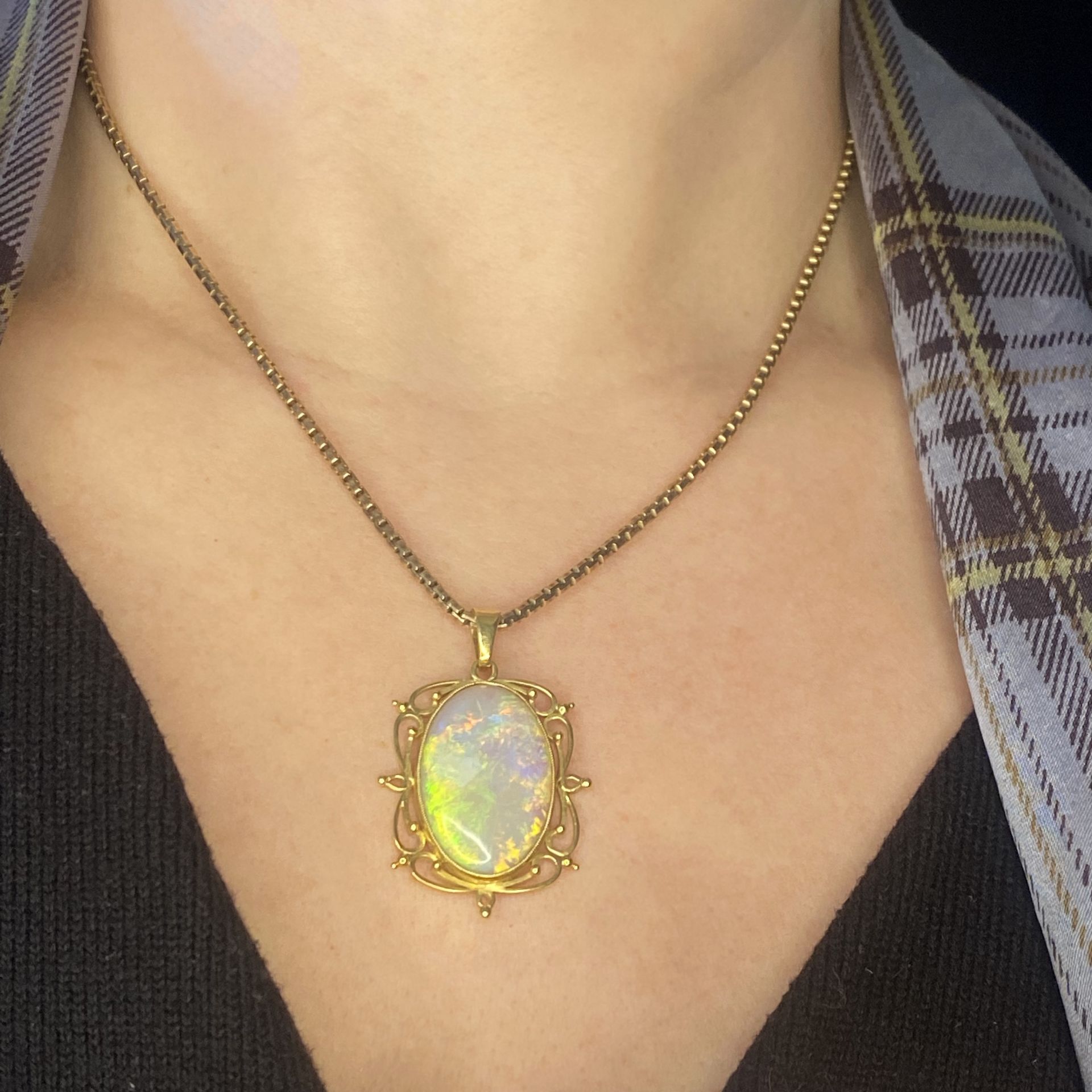 An opal pendant on chain, the opal cabochon to a pierced 18ct gold scrollwork mount, suspend... - Image 3 of 3