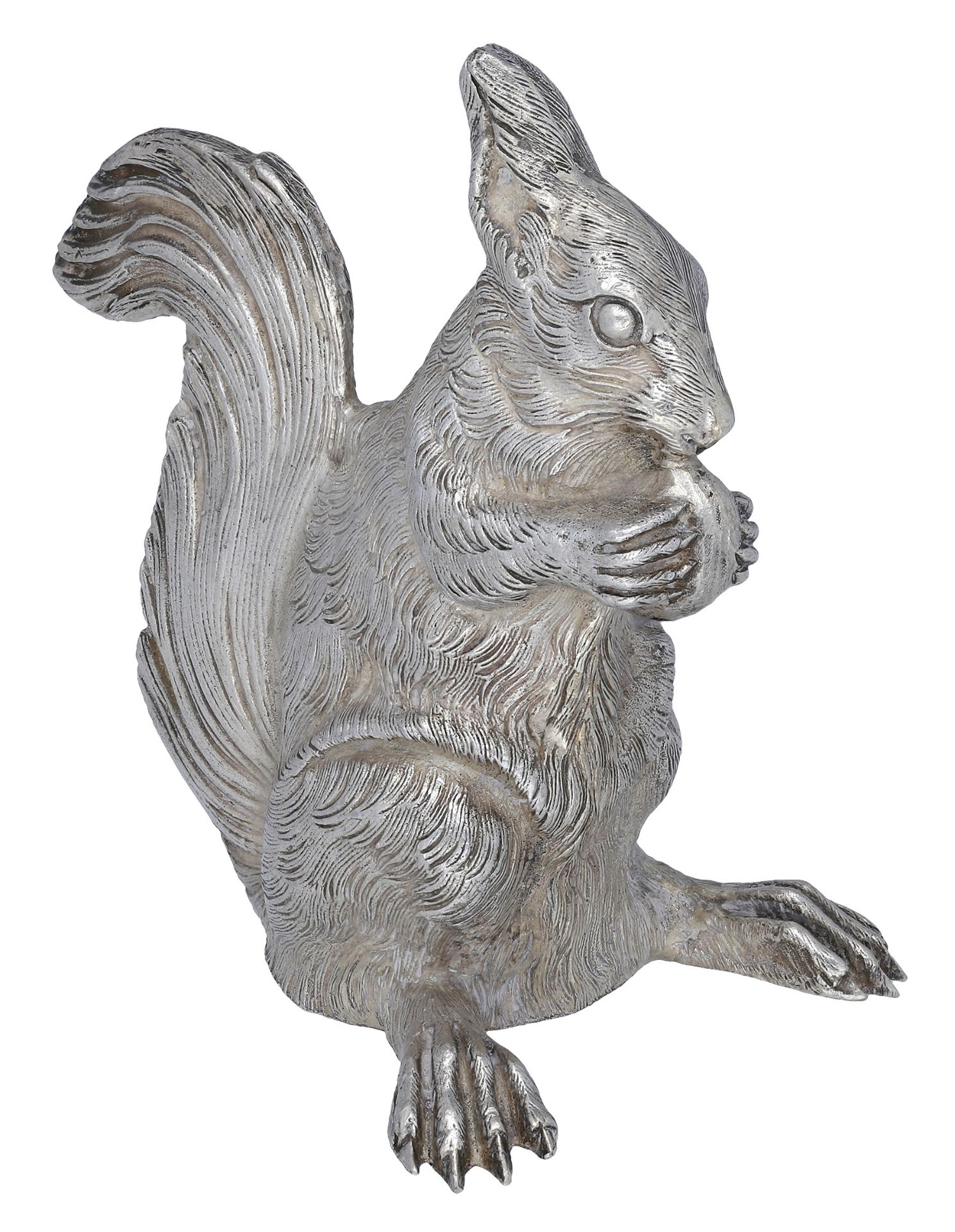 A French silver cast novelty pepperette modelled as a squirrel, eating a nut, the nut perfor...