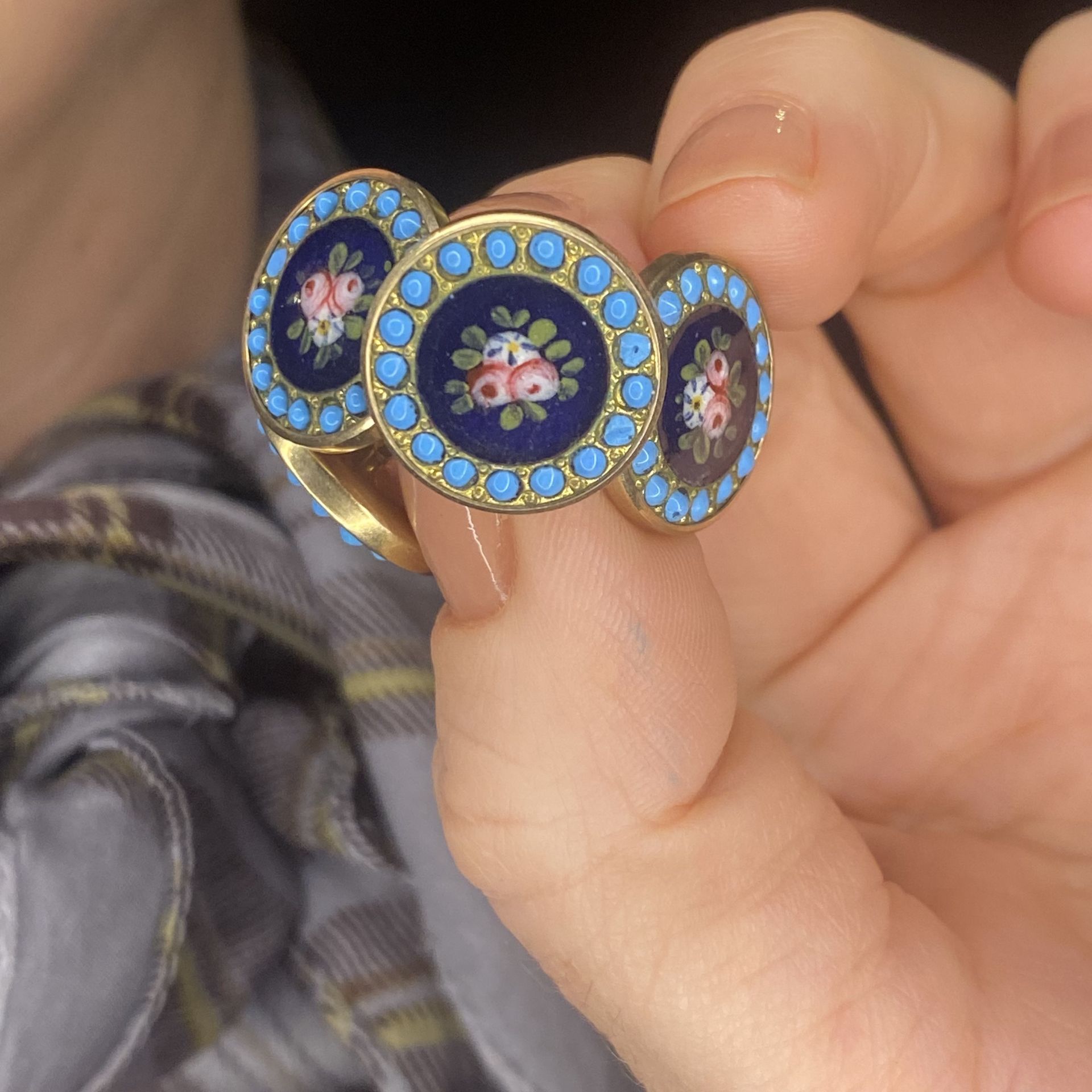 A pair of enamelled cufflinks, each of the circular panels comprising an enamel floral scene... - Image 3 of 3