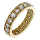 An 18ct yellow gold diamond eternity ring, claw-set throughout with brilliant-cut diamonds,...