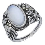 An Arts and Crafts silver moonstone ring, the cabochon collet set within a ropetwist border,...