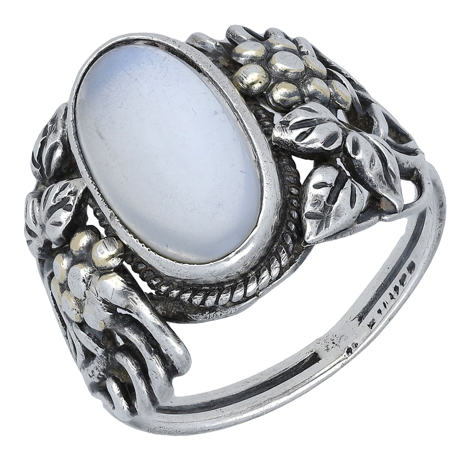 An Arts and Crafts silver moonstone ring, the cabochon collet set within a ropetwist border,...