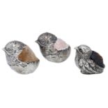 A matched pair of Edwardian silver chick pin cushions, the chicks hatching from their shells...