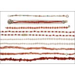 A small collection of coral and cultured pearl jewellery, comprising three bracelets, the fi...