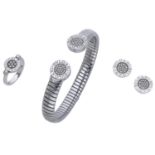 A tubogas suite by Bulgari, comprising a stainless steel and diamond sprung torque bangle, a...