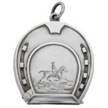 A Victorian silver horseshoe-shaped vesta case, the front engraved with a horse and rider, m...