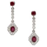 A pair of ruby and diamond ear pendants, the circular-cut ruby surmounts to a trio of milleg...