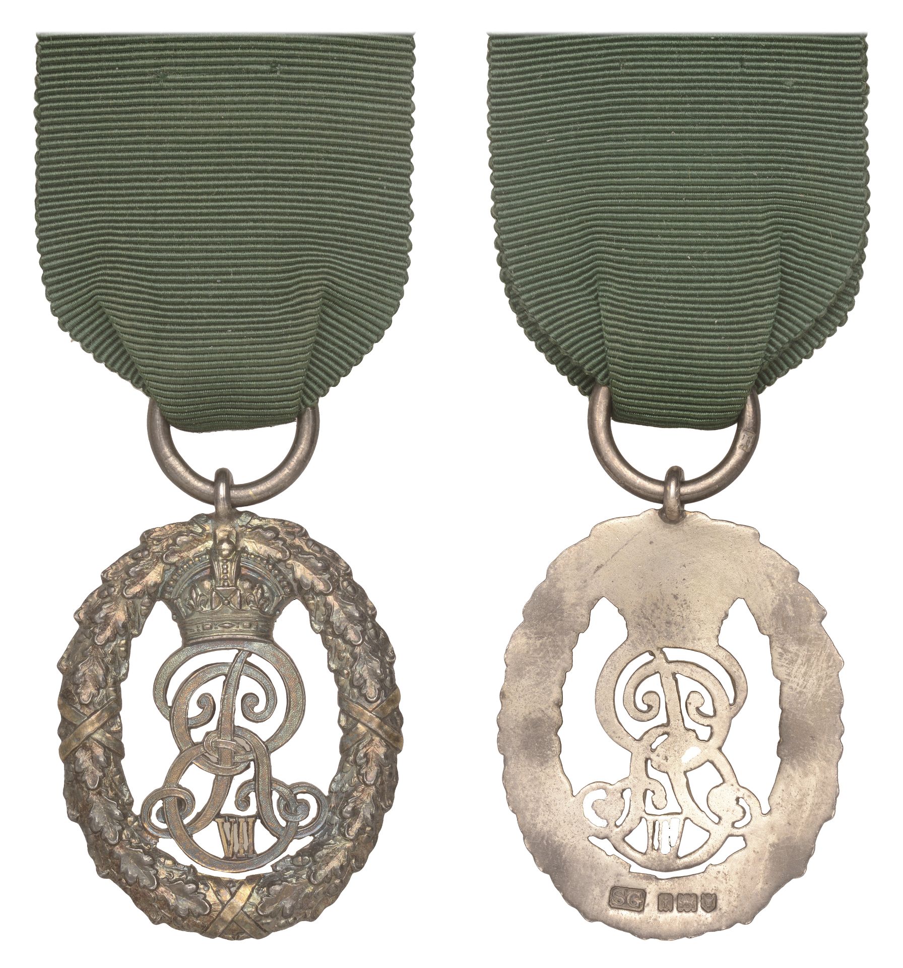 Volunteer Officer Decoration, a uniface silver medal by Garrard & Co., crowned cipher within...