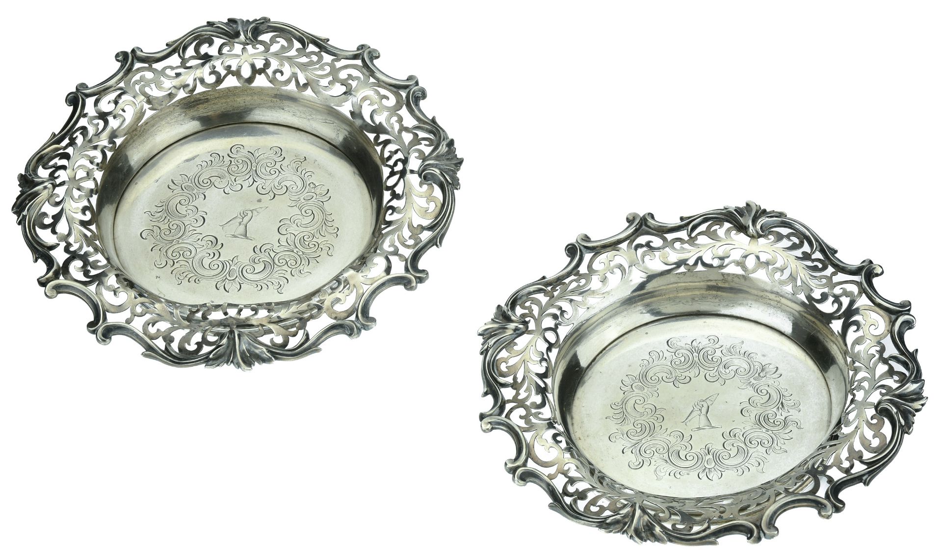 A pair of Victoria silver wine coasters, the broad, scroll-pierced borders with 'C' & 'S' sc...