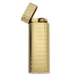 A gold plated lighter by Cartier, of flattened cylindrical section, with reeded engine turn...