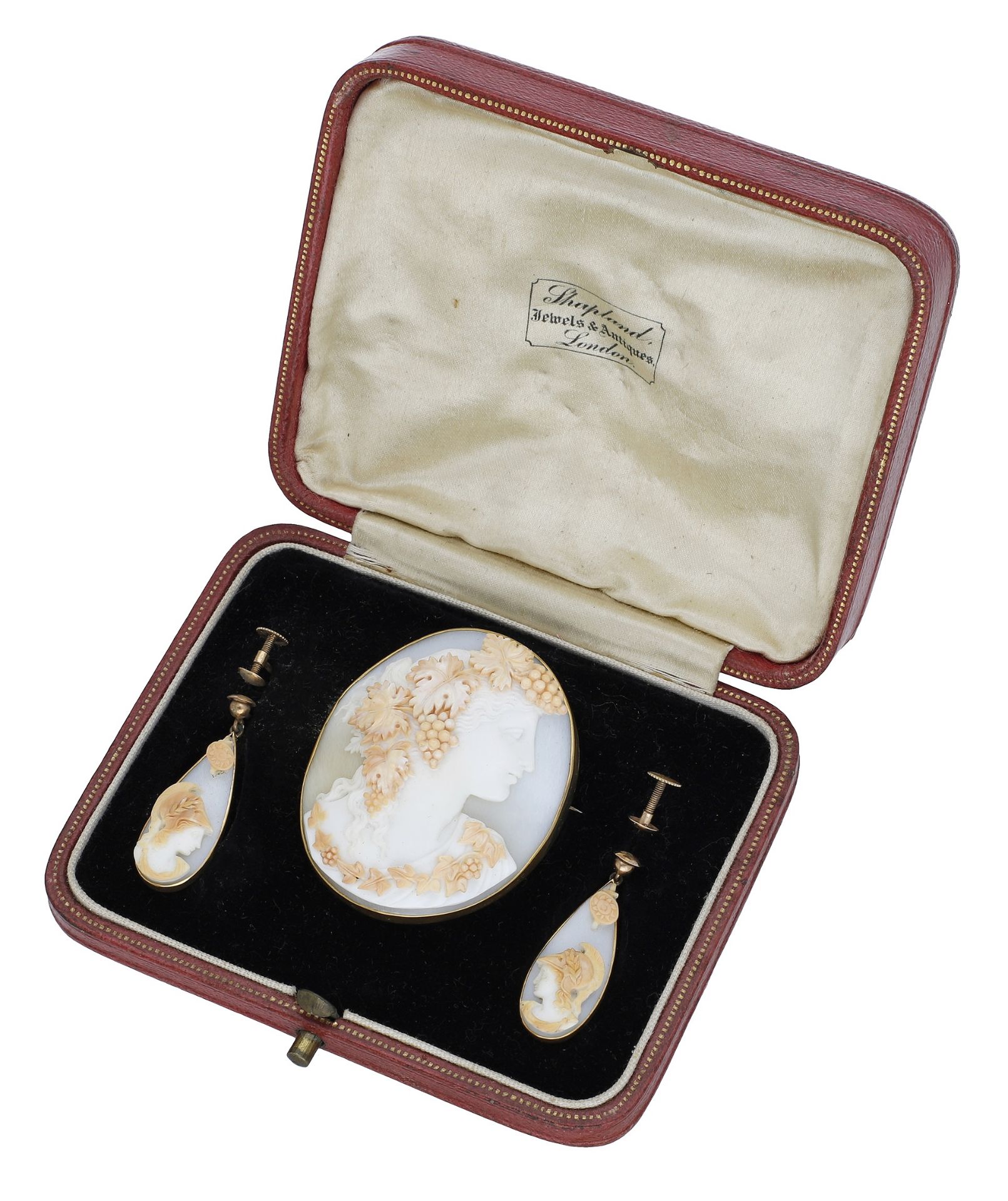 A 19th century shell cameo brooch and pair of earrings, the oval brooch carved to depict a b...