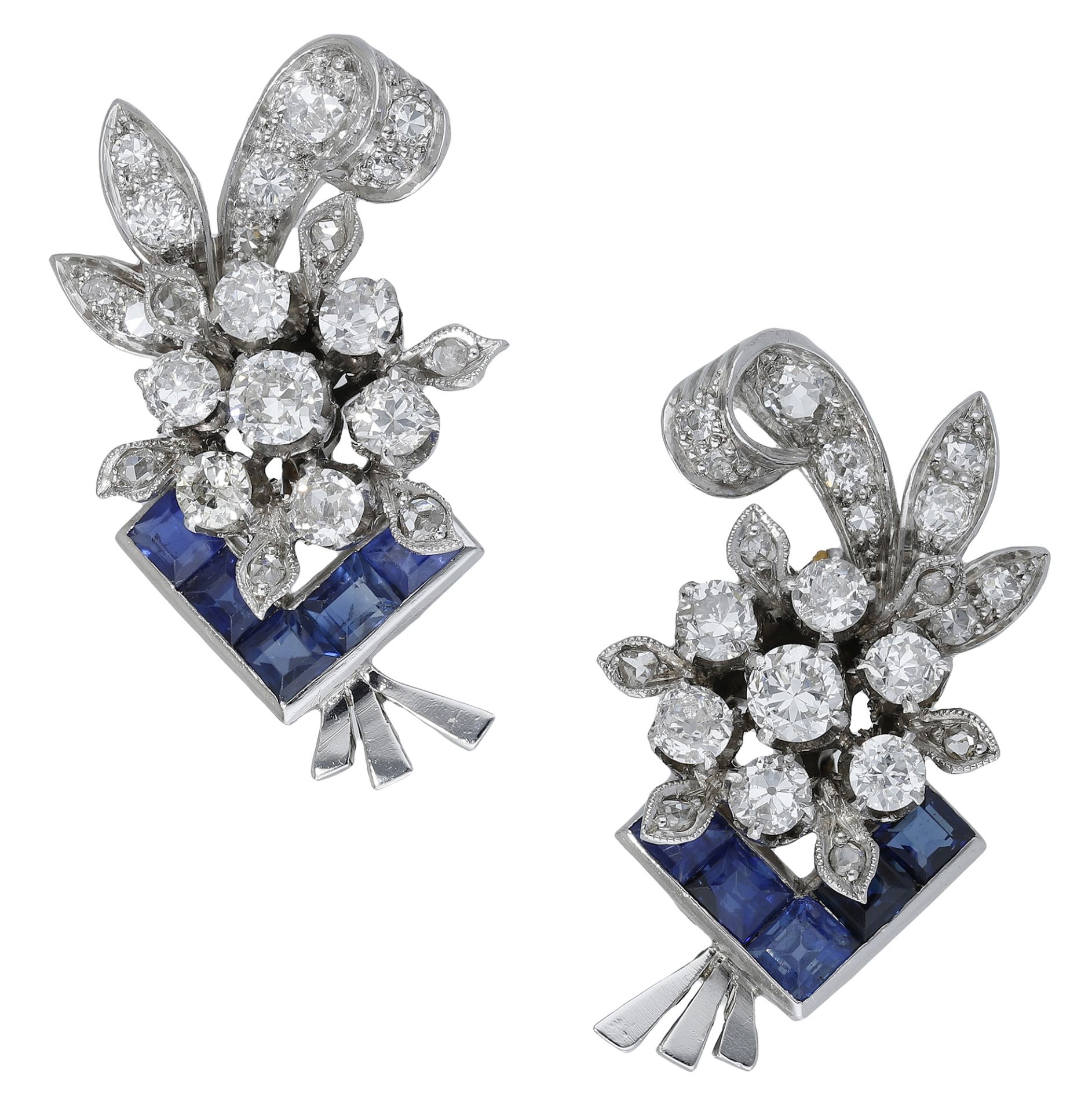 A pair of sapphire and diamond earrings, circa 1950, the foliate sprays set throughout with...