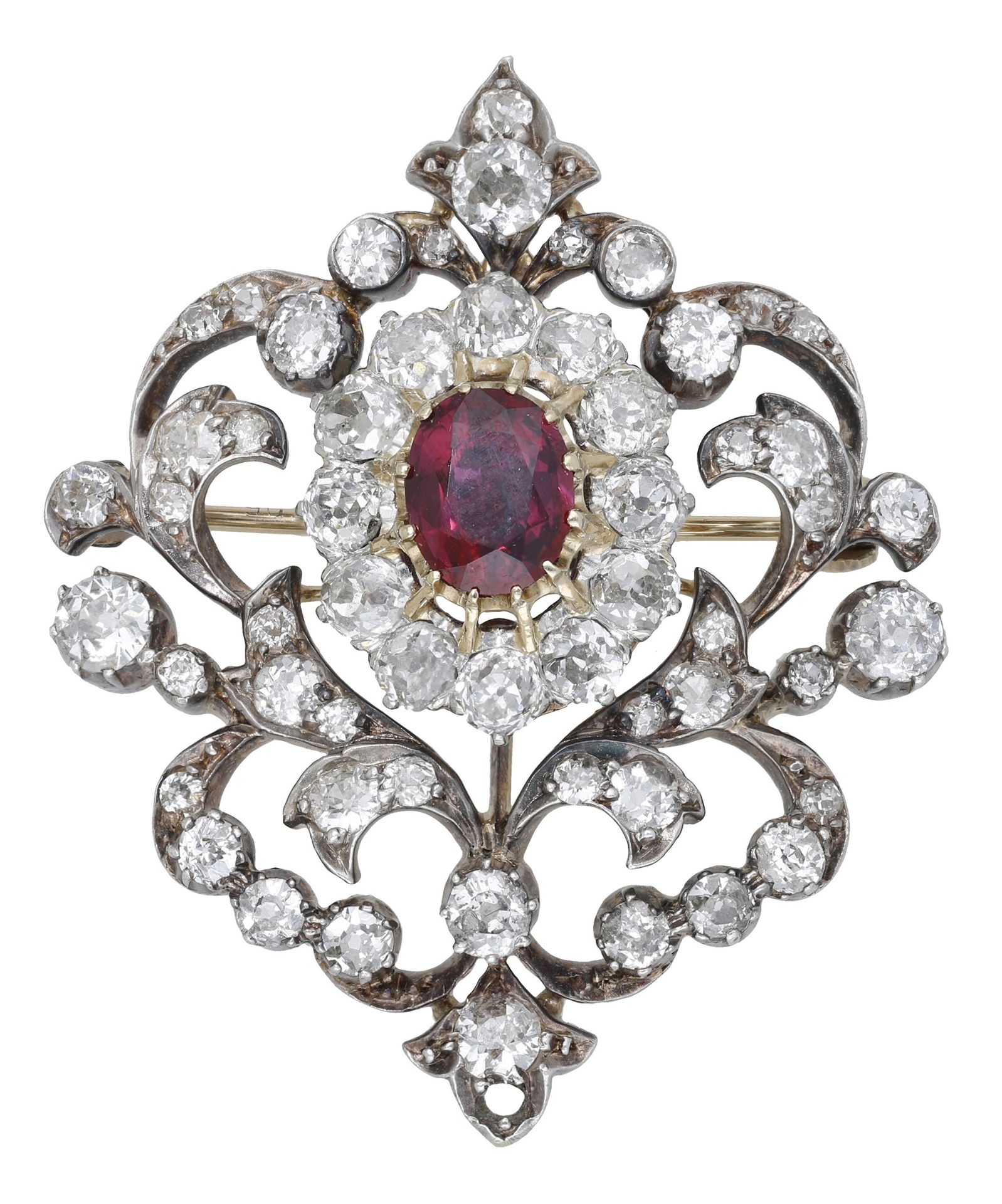 A ruby and diamond brooch, circa 1890, the openwork scrolling cartouche set centrally with a...