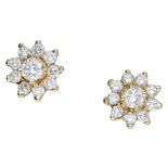 A pair of diamond cluster ear studs, each designed as flowerhead cluster and set throughout...
