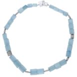 An aquamarine necklace, the aquamarine hexagonal crystal beads spaced by silver discs with s...