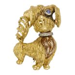 An 18ct gold novelty dog brooch, 1966, with textured fur, diamond set colour and single sapp...