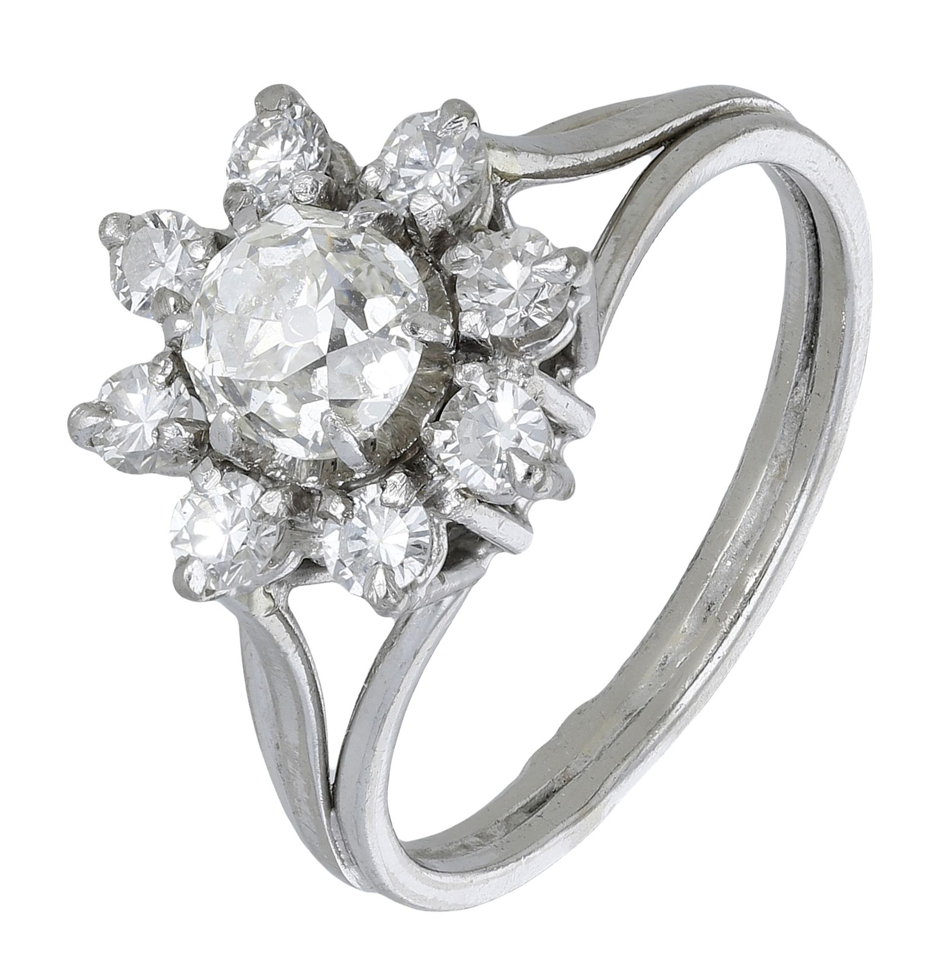 A diamond flowerhead cluster ring, centred with an old-cut diamond within a surround of bril...