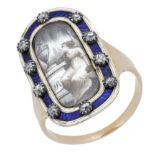 A late 18th century memorial ring, the oblong shaped panel centred with a glazed en grisaill...