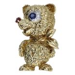 A novelty brooch by Kutchinsky, circa 1970, designed as a bear with circular-cut sapphire an...