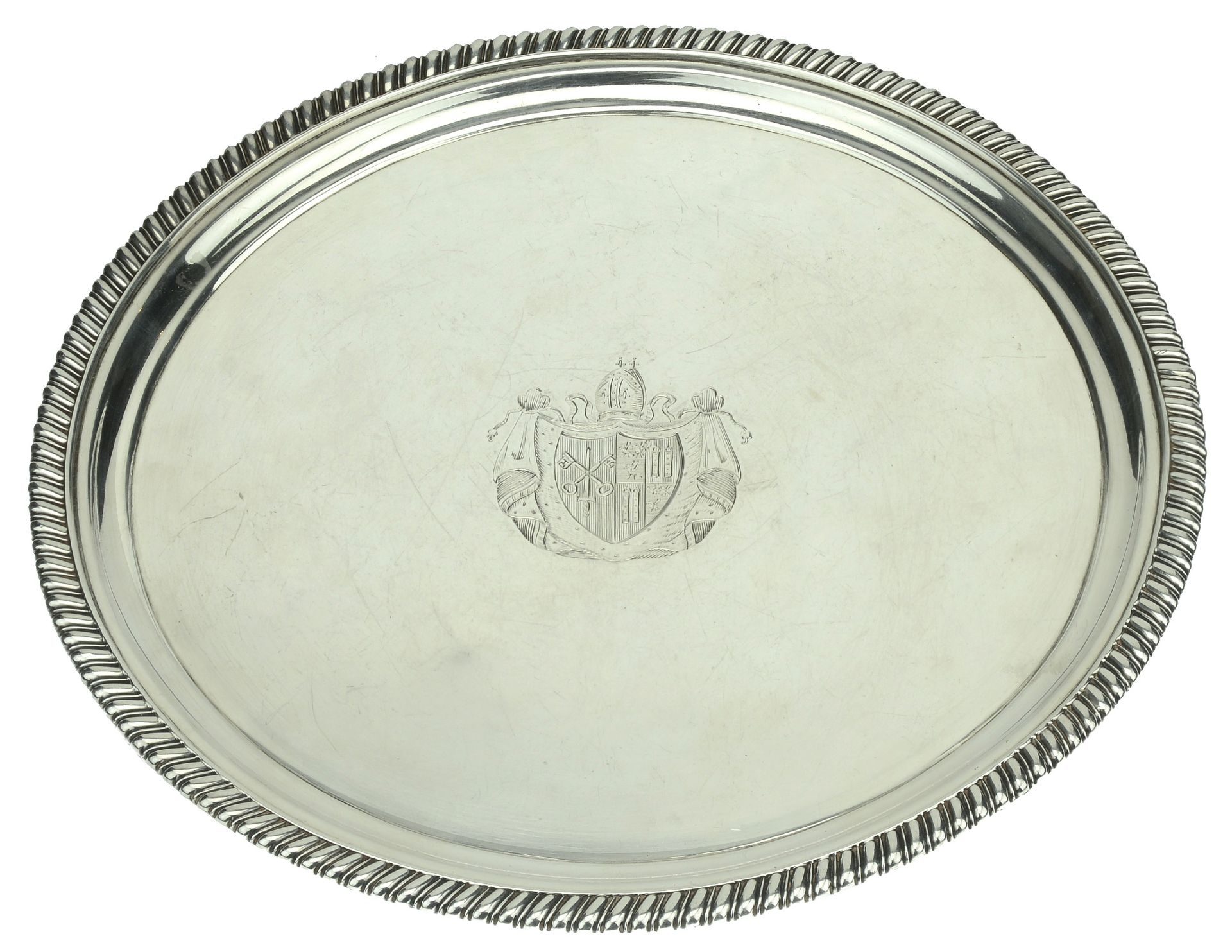 A George III silver salver, with gadrooned border, on three gadroon-edged feet, centred with...