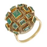 An emerald set dress ring, the domed ring of textured bombÃ© form, collet-set throughout with...