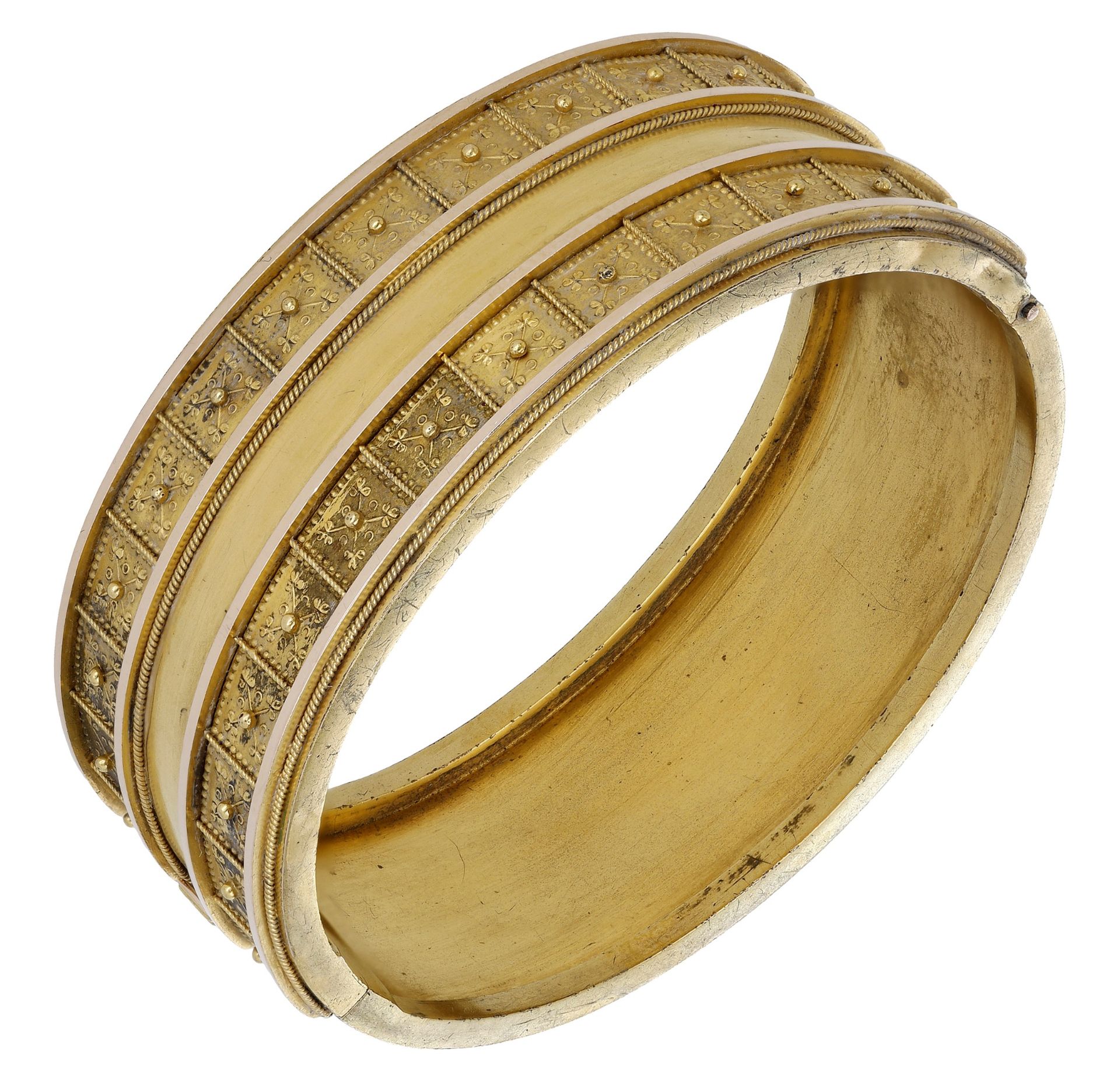 A 19th century archaeological revival hinged gold bangle, with applied granulation and ropet...