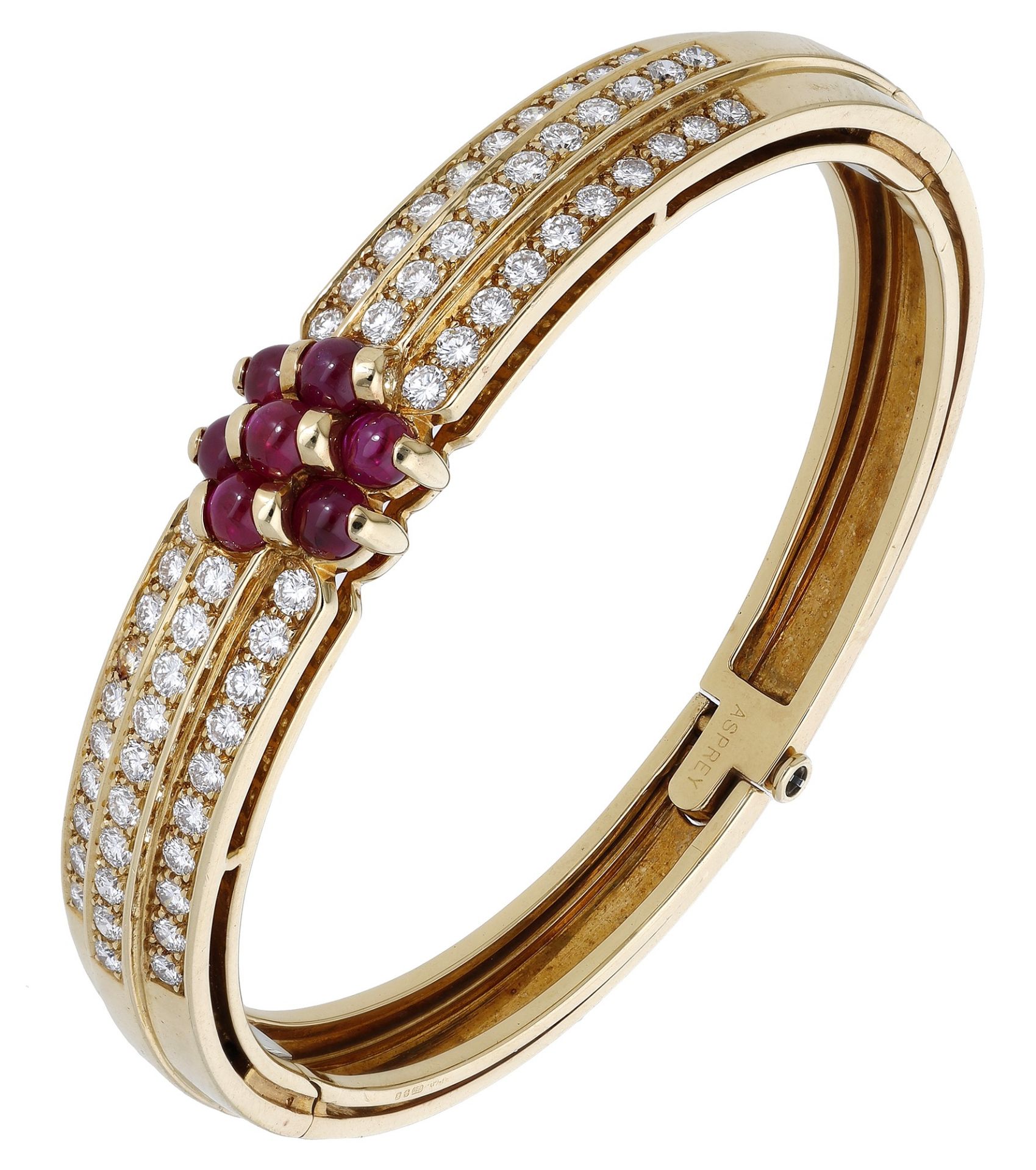 A French ruby and diamond bangle by Serge Bouder for Asprey & Co., the hinged cuff with thre...