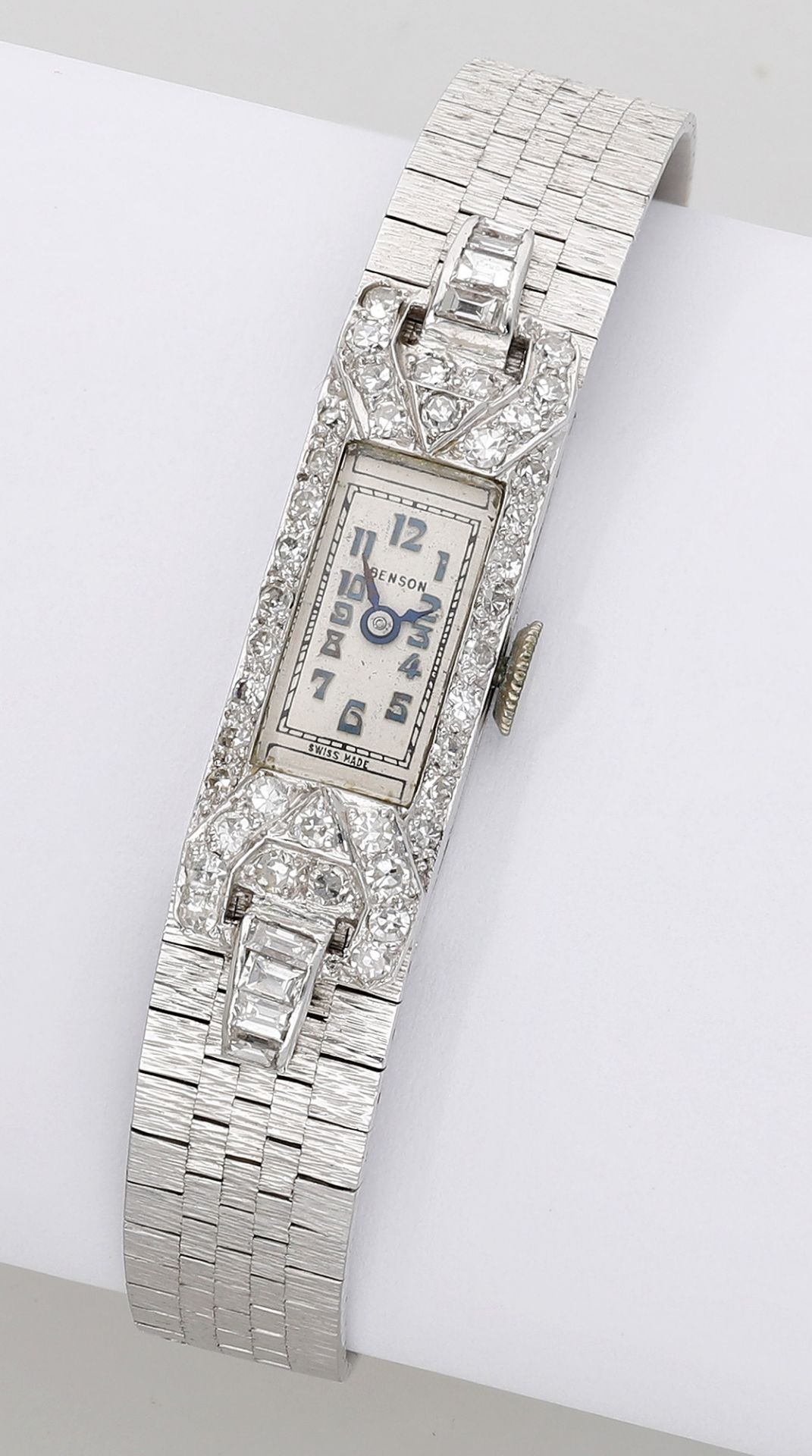 Swiss, retailed by Benson. A lady's platinum and diamond-set cocktail watch with later added...