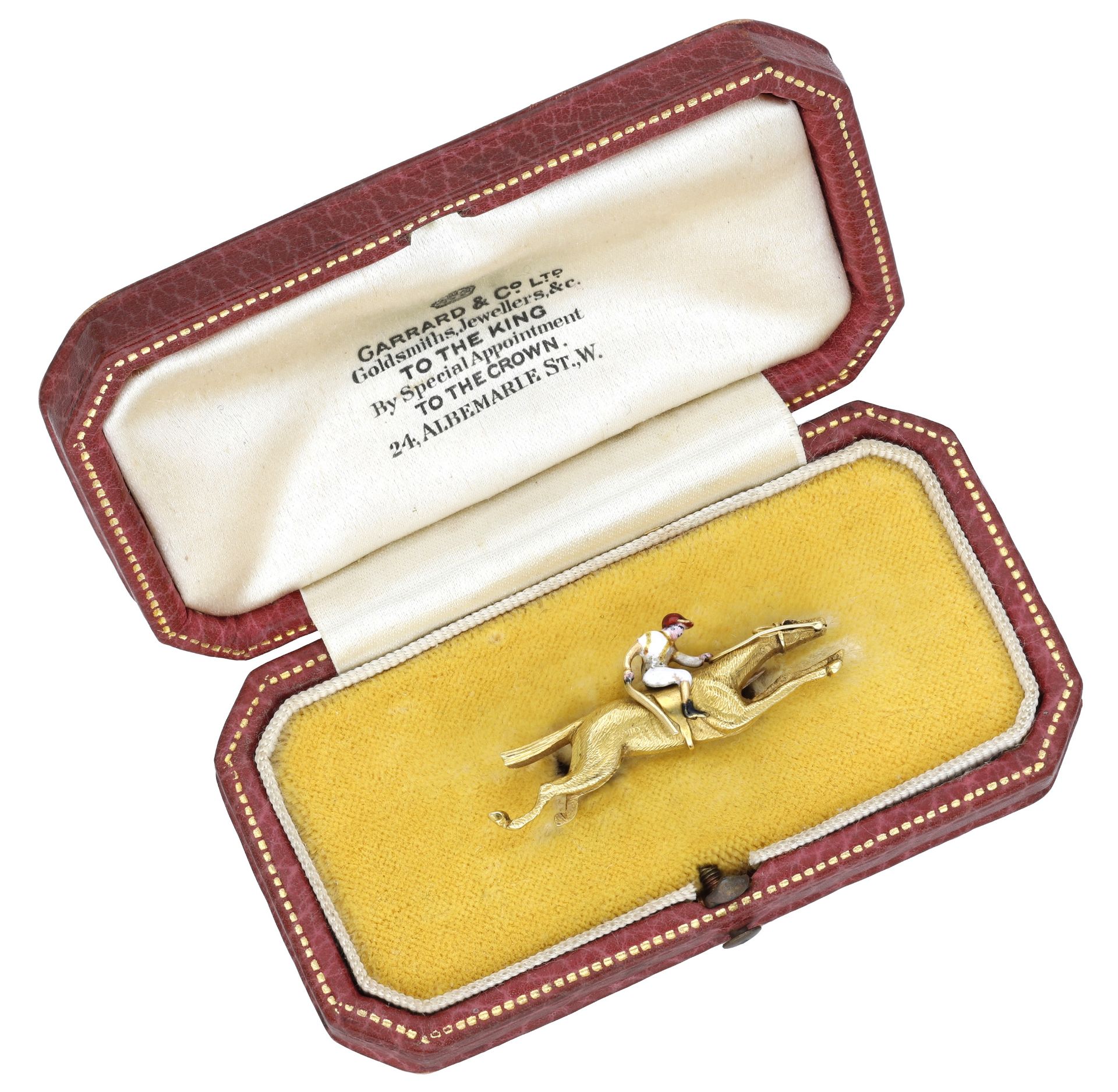 Of racing interest: An early 20th century gold and enamel jockey brooch, retailed by Garrard...