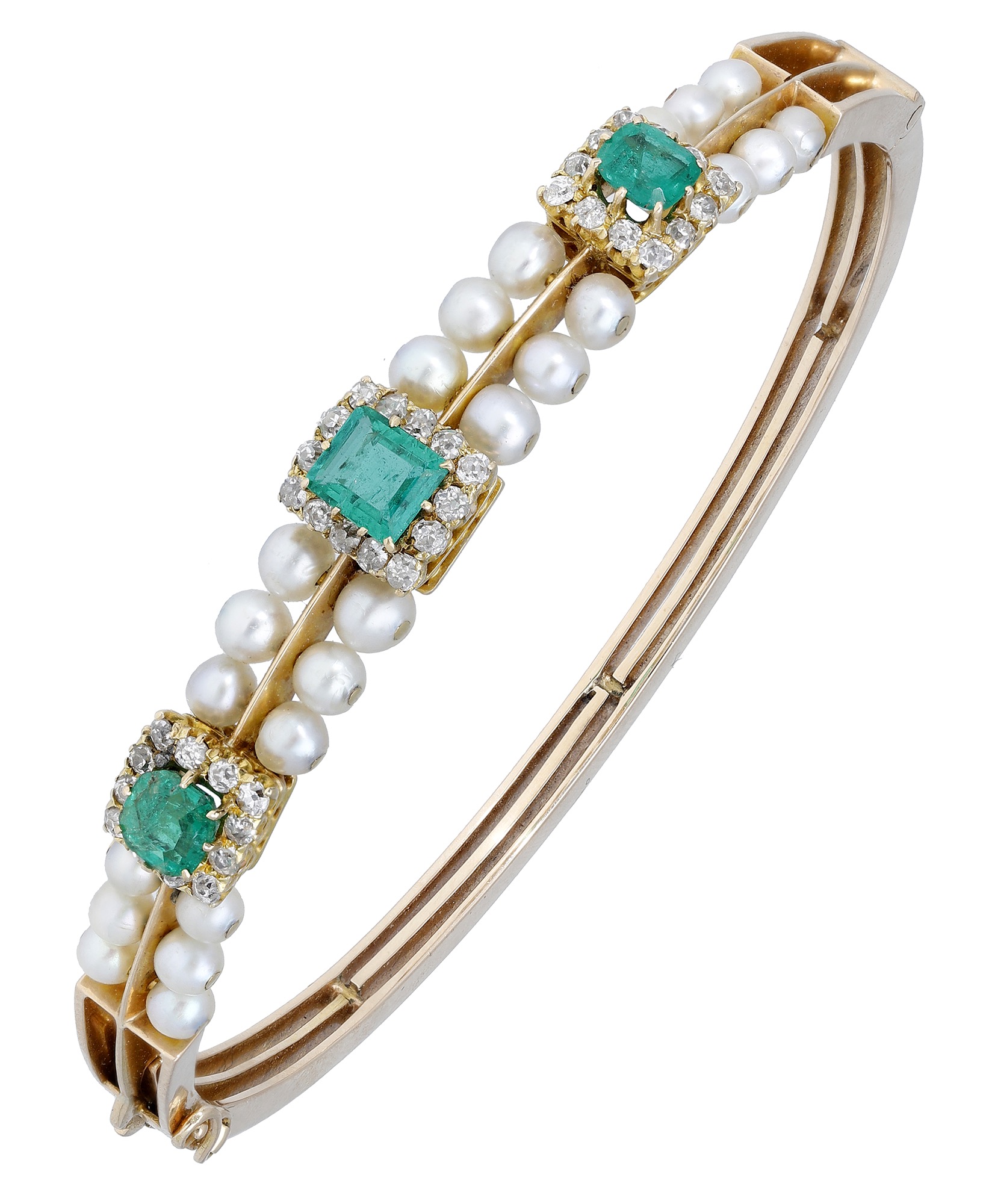 A late 19th century emerald and pearl bangle, set to the front with a central step-cut emera...