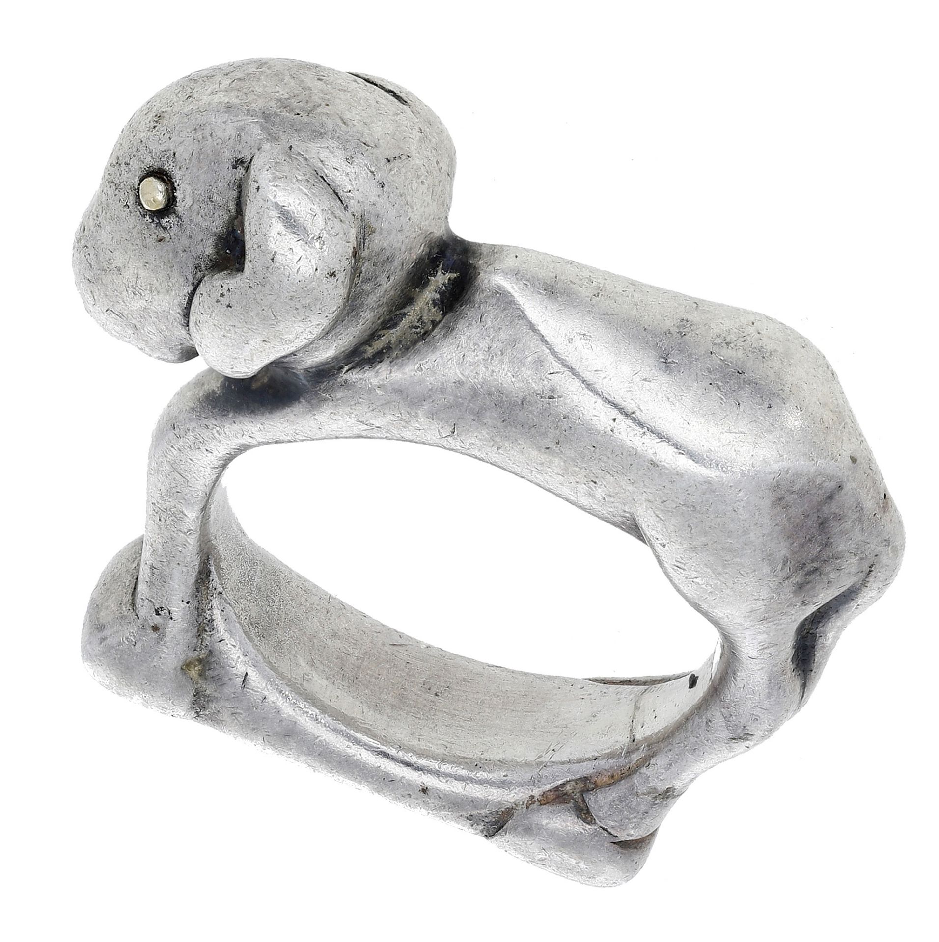A silver figural ring by Mosheh Oved, circa 1940, the angular design modelled as a lamb, wit...