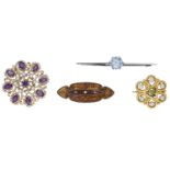 A small collection of gem-set brooches, including a pierced amethyst and seed pearl brooch,...