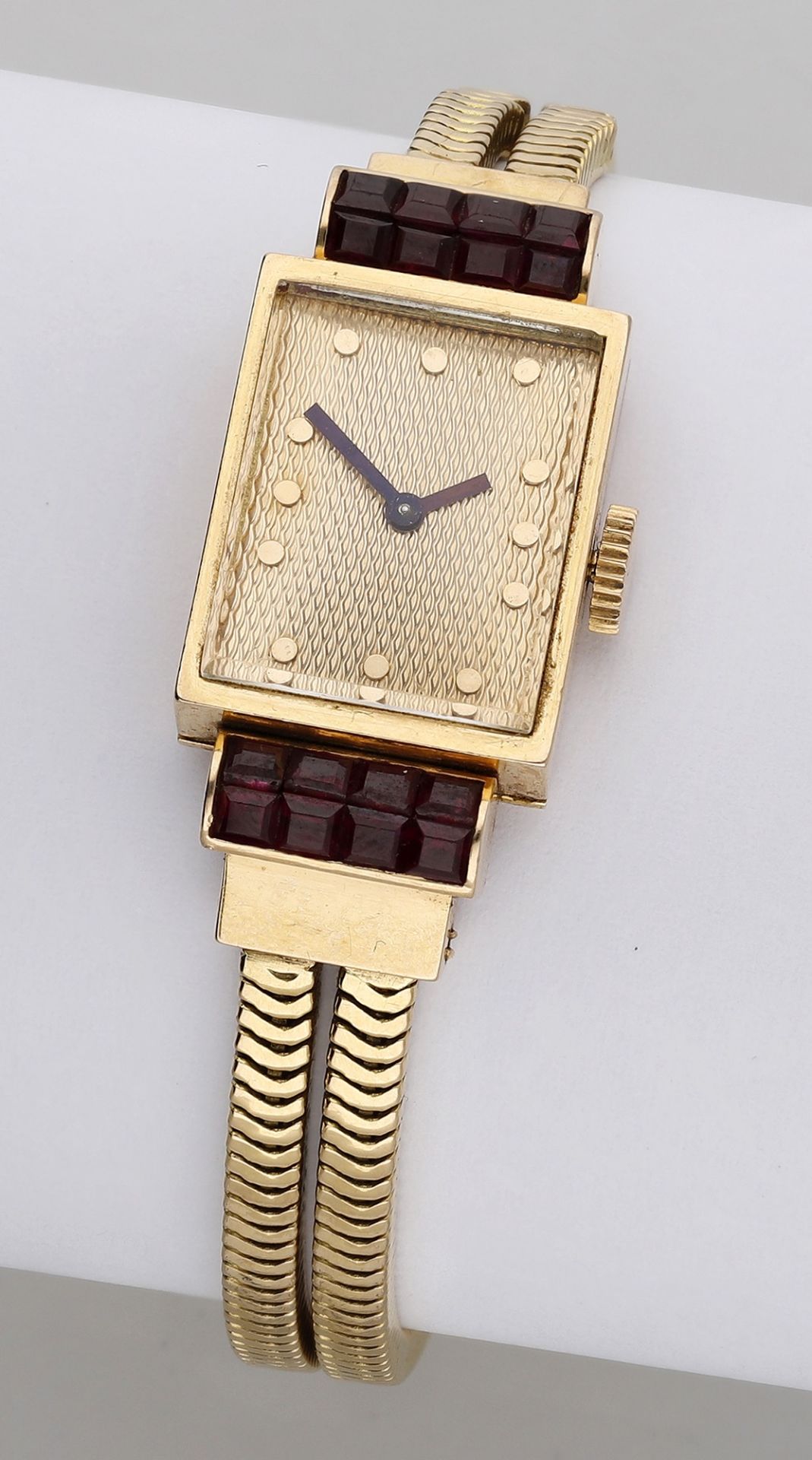 Boucheron. A lady's gold and synthetic ruby-set bracelet watch, circa 1956. Movement: cal....