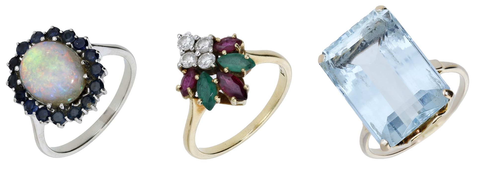 An 18ct gold vari gem-set ring by Kutchinsky, an aquamarine dress ring and an opal cluster r...