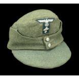 A German Second World War Army Enlisted Man's M.43 Cap. A composite cap, converted from an...