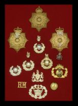 Miscellaneous Cap Badges. A selection of mainly 20th-century Regimental Cap Badges mounted...