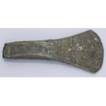 Bronze Age, a flat axe with side flanges, c. 1800-1500 BC, 15.5cm long by 7cm wide by 2cm de...
